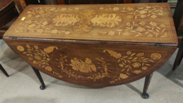 An 18th century dining table with oval drop leaf top and extensive floral marquetry inlay, on pad