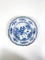 A Chinese porcelain plate with shaped rim decorated in under glaze blue with genre scene, 22cm