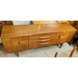 A mid 20th century teak sideboard with cupboard to each end and three central drawers, length 183cm,