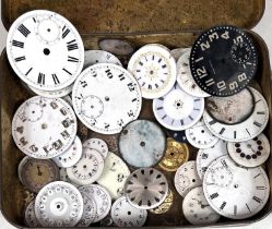 A tin containing a quantity of differing size watch faces and some movements.