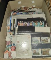 A collection of presentation packs and loose stamps.