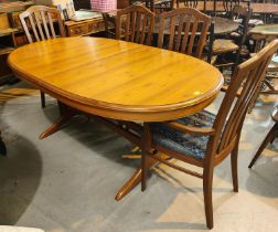 A Staf light teak extending dining table with extra interior leaf and a set of 6 (4+2) chairs