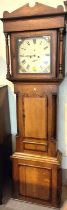 An early 19th century oak and mahogany longcase clock with architectural pediment and turned columns