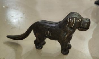 A cast metal nut cracker in the form of a dog