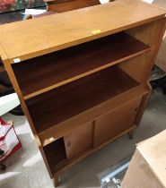 A 1950's bookcase/side cabinet with open shelves and cupboard under