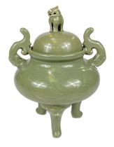 A Chinese celadon glaze lidded centre, three legged with mythical beast finial, ht. 25cm