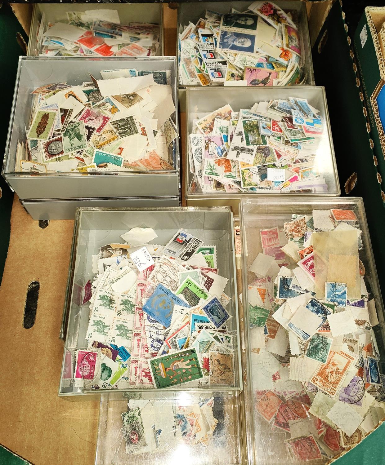 A large collection of loose stamps.