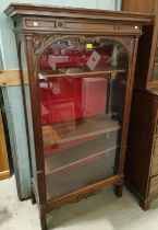 A narrow Edwardian mahogany full height display cabinet enclosed by single door on square legs, 4