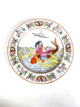 A Chinese porcelain plate decorated with man astride a large carp, 25.5cm