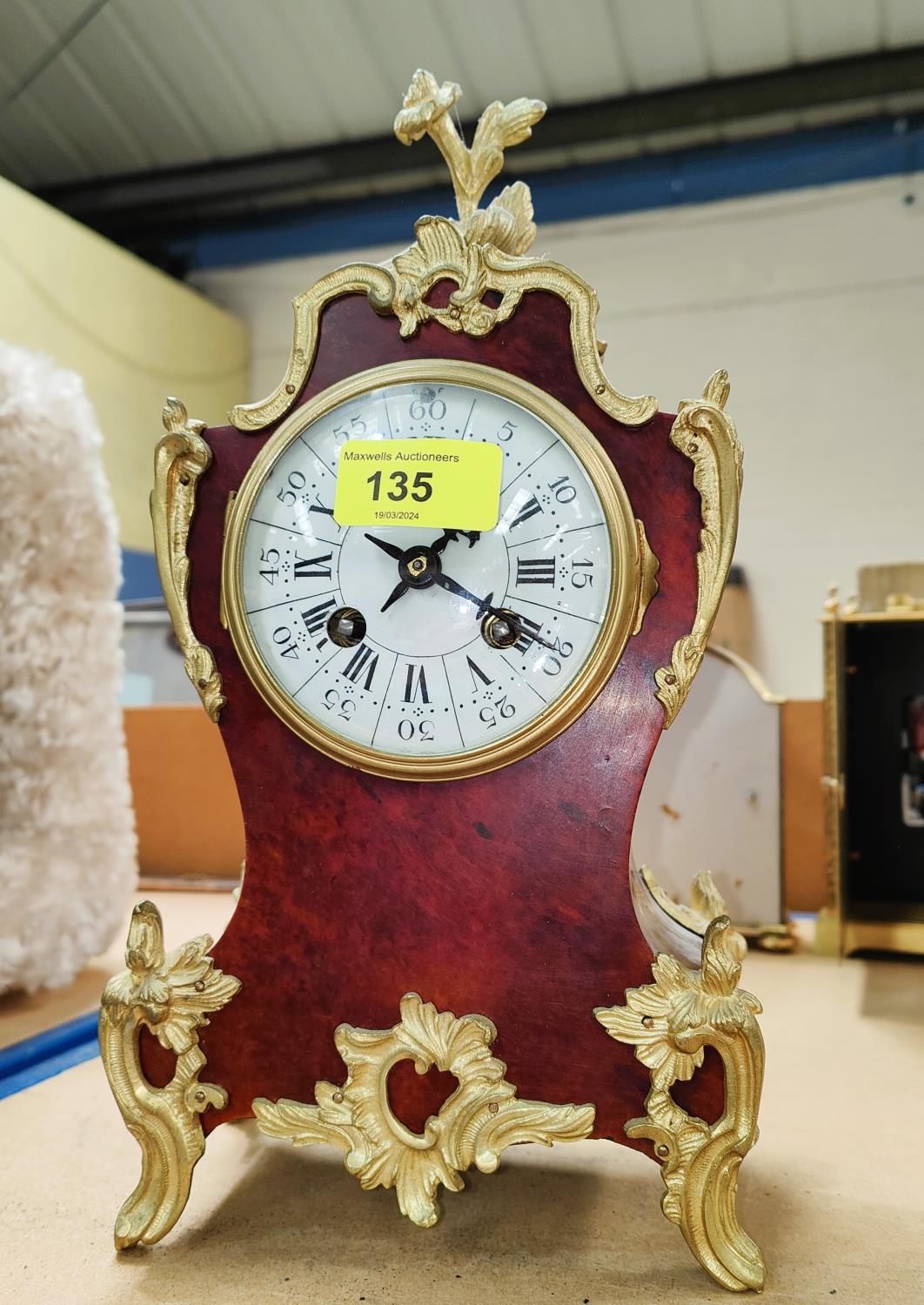 A 19th century Louis XV style mantel clock in tortoiseshell effect case with extensive ormolu mounts