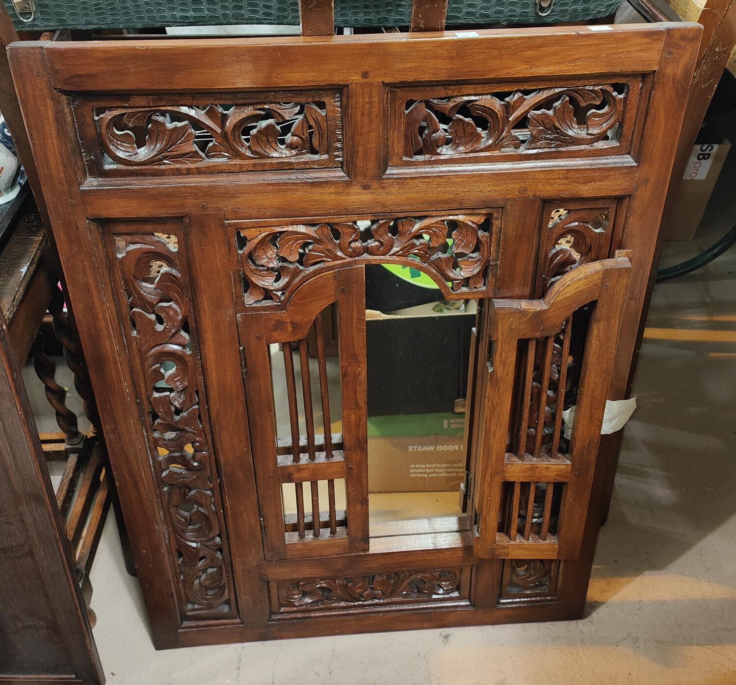 An Indonesian hardwood rectangular mirror with folding shutters; 2 large oak trays