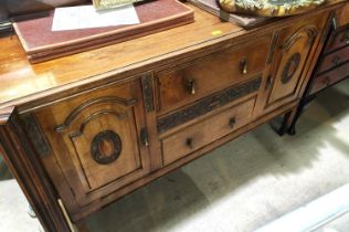 An early 20th century mahogany sideboard with 2 arch panel end cupboards and 2 central drawers on