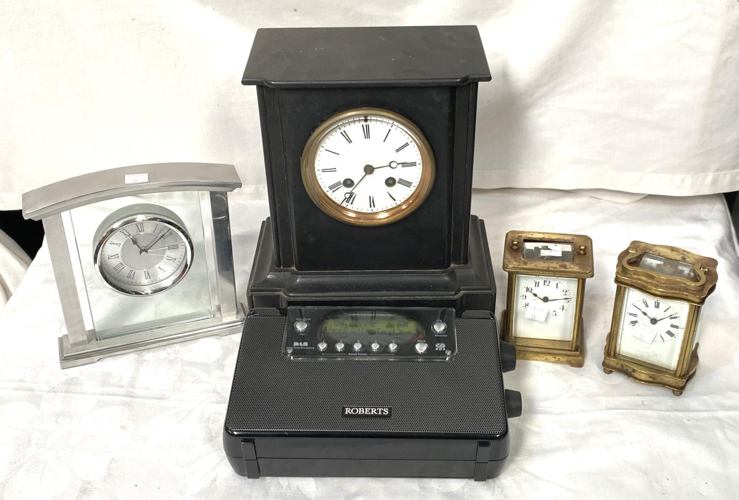 A slate mantel clock with enamel dial, Roman numerals, two brass carriage clocks, a.f