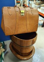 A tan leather Gladstone type bag; a wooden bucket and trough.