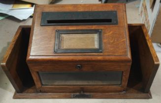 An early 20th century oak table top post box with metal letter post slot, bevelled glass