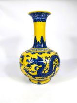 A Chinese porcelain vase of globular form with elongated neck and everted rim, decorated in