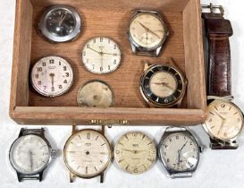A small box containing a variety of wristwatches (only one with strap).