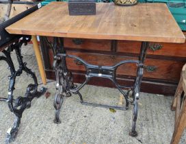 A cast metal based pub table with stained wooden top, 120 x 70cm; a table with cast iron treadle