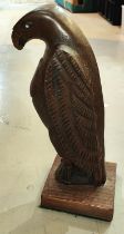 A carved figure of an eagle with white eyes