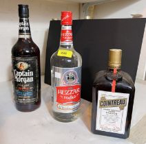 A 1 litre bottle of "Captain Morgan Rum"; a 1 litre bottle of "Huzzar Vodka"; a litre bottle of "