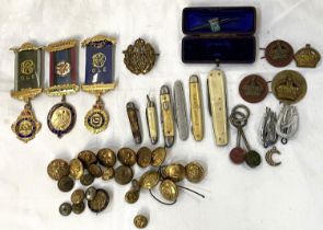 A collection of military buttons; badges; penknives; etc.