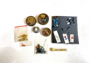 A selection of loose opals and semi precious stones (the opals applied to card with vegetable glue)