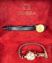 A lady's Omega wrist watch, another Omega De Ville lady's wrist watch and a Raymond Weil watch in an