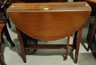 An Edwardian oval walnut Sutherland table on square splay legs