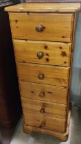 A modern pine tall thin chest of six drawers