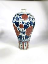 A Chinese porcelain octagonal meiping vase decorated in underglaze blue and iron red with stylised