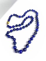 A lapis lazuli bead necklace with 9 carat hallmarked gold ball clasp