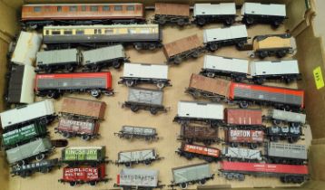 Forty three carriages/cars/trucks, some with advertising decals, 00 gauge