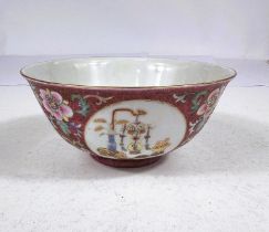 A Chinese bowl with pink ground, circular panels of vases and objects, seal mark to base, diameter