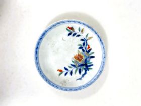 A Japanese porcelain dish decorated with a fruit nestled in a branch, 4 character mark, 15cm (