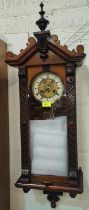 A 19th century small walnut cased wall clock in the Vienna style, with spring driven movement