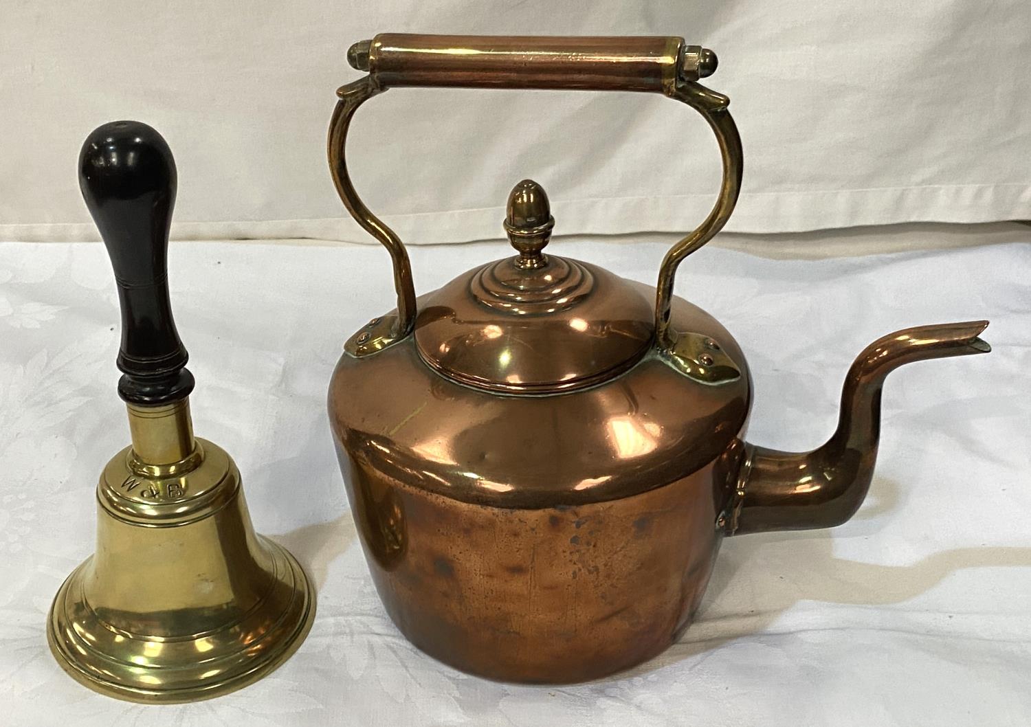 A 19th century copper kettle; a 19th century school bell