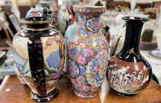 A mid 20th century bulbous, slender neck Japanese vase decorated with a large group of women, ht.