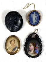 A 9ct gold surround Wedgwood Jasperware blue and white cameo brooch, a carved jet mourning brooch
