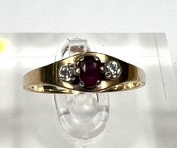 A 9 carat hallmarked gold ring set central ruby and 2 diamonds, 2gm
