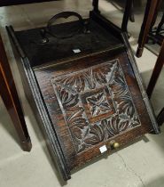 A carved coal box with slope front