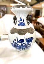 A Chinese porcelain baluster shaped vase decorated in under glaze blue with battle scene, bronzed