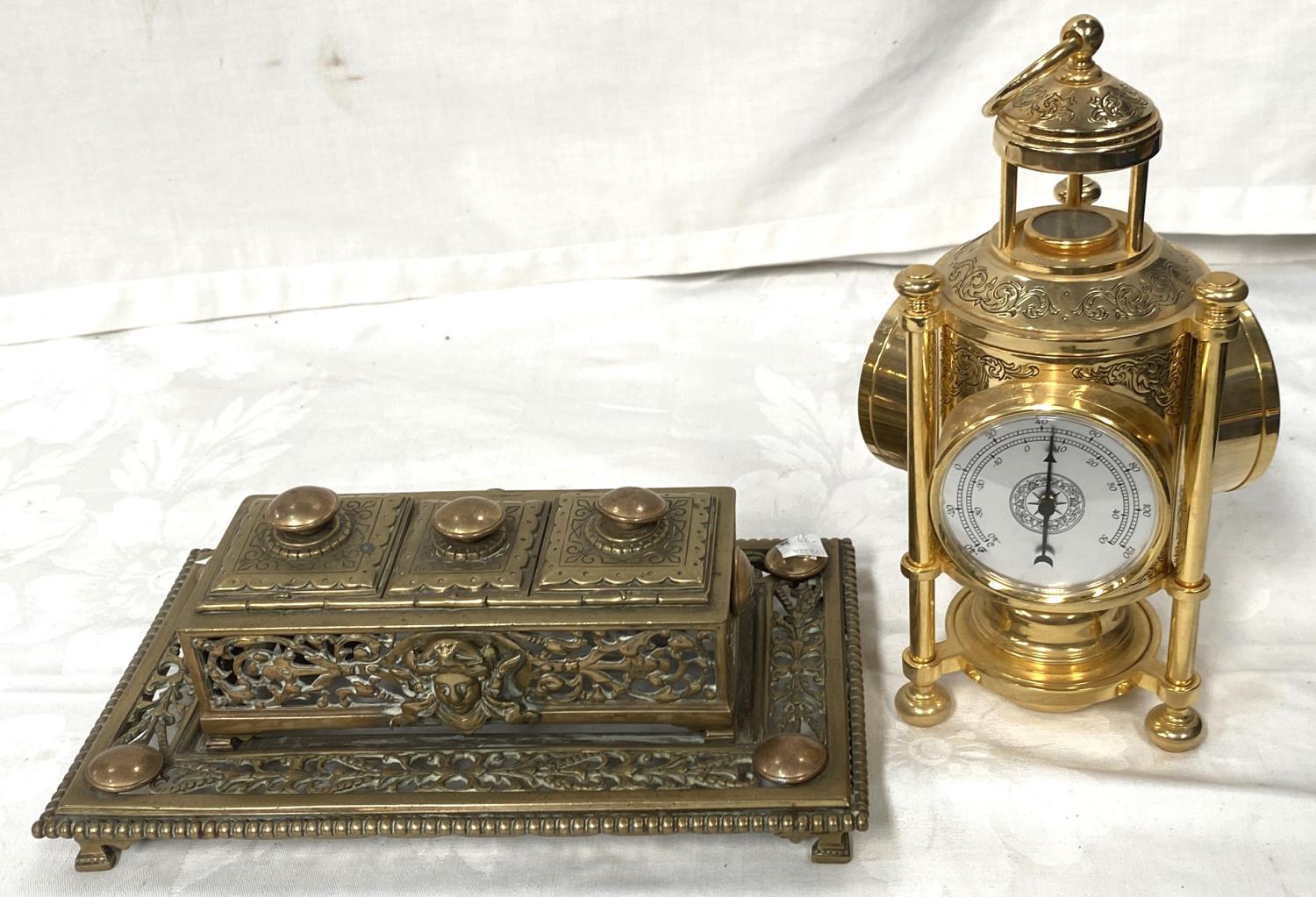 A reproduction brass meteorological clock with three faces and a brass 19th century inkwell with