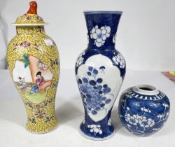 A Chines yellow ground baluster shaped covered vase decorated with jenne? panels, 28cm; a blue and