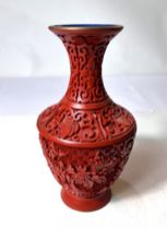 A Chinese boxed cinnabar coloured vase, height 20cm.