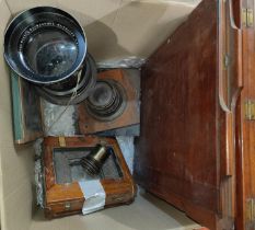 A collection of lantern and vintage camera parts including very large lens and smaller