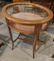 An Edwardian oval bijouterie cabinet in Sheraton style inlaid mahogany, on square tapering legs