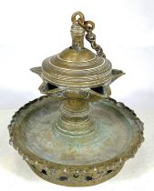 An antique Middle Eastern possibly Islamic oil lamp with five star shaped spouts, ht. 18cm