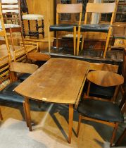 A mid 20th century teak dining table, circular form with drop leaves and a set of 6 matched teak