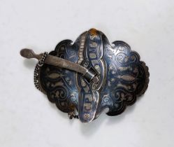 A Russian style white metal Niello belt buckle with typical black decoration, oval shaped convex