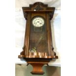 A 19th century Vienna wall clock in walnut case, spring driven with strike